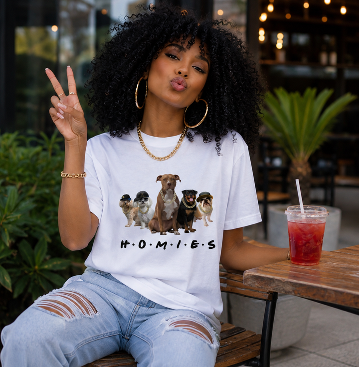 Woman wearing white Hip Hop HOMIES Pit Bull T-shirt at a cafe